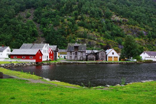 Traditional wooden houses on hillside background in Lyrdal, Norway