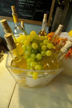Bottles of white wines with a grape