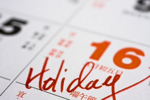 Hand writing holiday important date on calendar