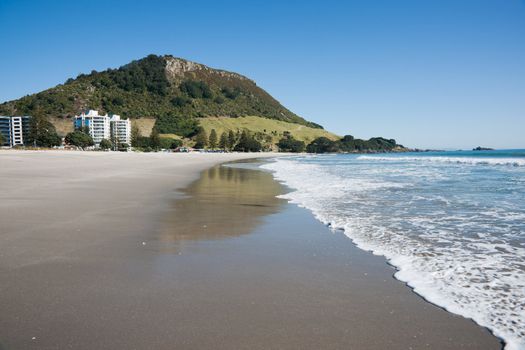 Mount Maunganui, Beach scene at low tide, with reflections in sand.