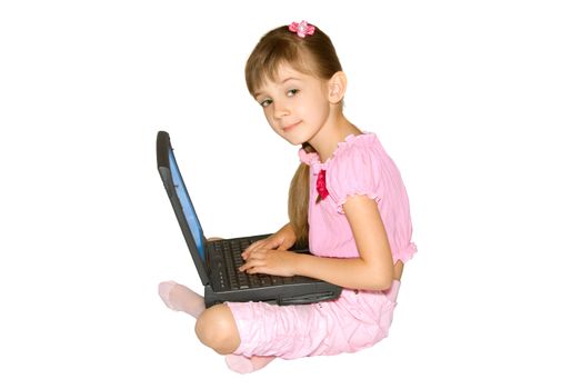 The girl in pink clothes sits with a notebook computer