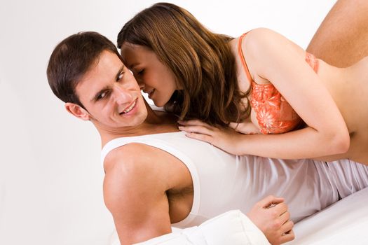 Young adult couple in the studio on a bed