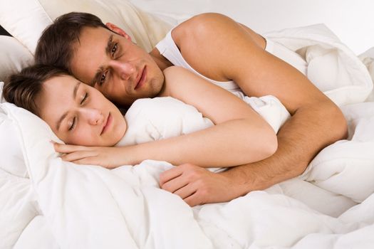 Young adult couple in the studio on a bed