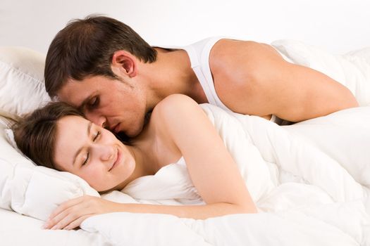 Young adult couple in the studio on a bed