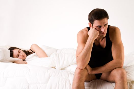 Young adult couple in the studio on a bed