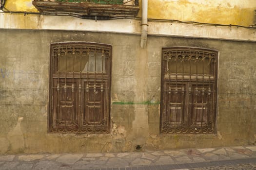Old street with rusty walls, Brihuega, Spain.