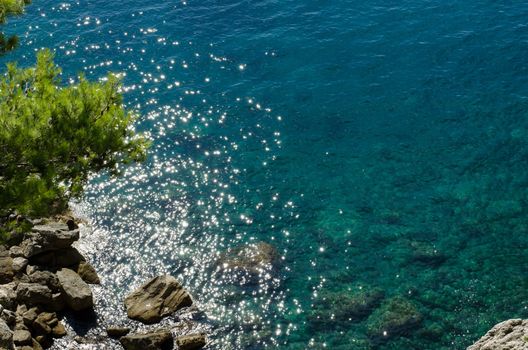 View of the Adriatic sea from above with sunshine stars in the water