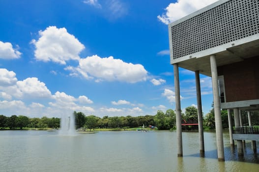 building at poolside and fountain in blue sky