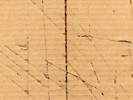 Brown grunge corrugated cardboard sheet useful as a background