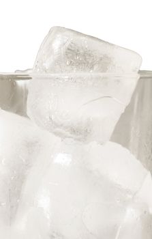 Close up of glass full of ice cubes over white