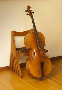 cello or violincello resting against chair