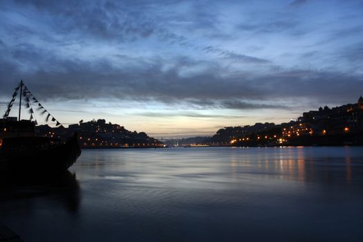 Night view of the old historical area of Porto city on Portugal by the river.