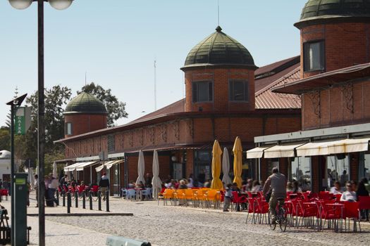 View of the traditional market area of the city of Olhao in Portugal, with people walking around.