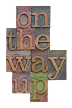 On the way up - phrase in vintage letterpress wooden printing blocks,  stained by color inks, vertical layout, isolated on white