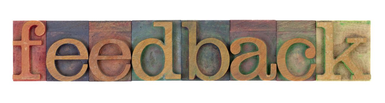 feedback word in vintage wooden letterpress printing blocks, stained by color inks, isolated on white