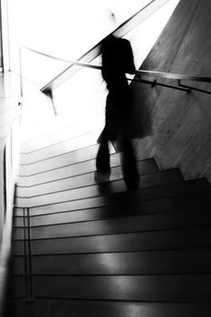 Ghostly dark figure out of focus, descending some staircase.