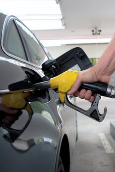 Close-up pumping gasoline on the black car 