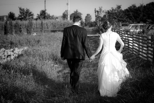 Young married couple walking on a countryside trail