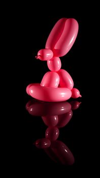 Balloon rabbit isolated on black with reflection