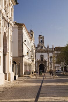 View of the main recreational plaza and Arc of Vila on the city of Faro, Portugal