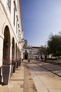 View of the main recreational plaza and Arc of Vila on the city of Faro, Portugal