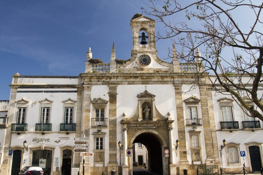 View of the main recreational plaza and Arc of Vila on the city of Faro, Portugal