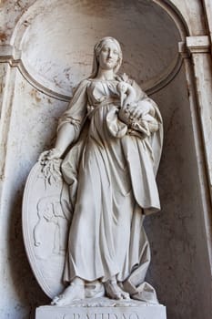 Close view of a statue of a women located on the entrance of the National Palace of Ajuda in Lisbon, Portugal.