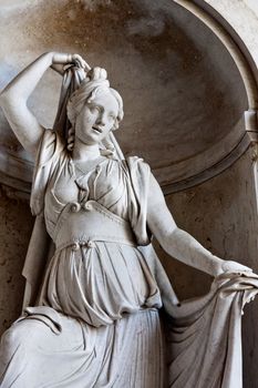 Close view of a statue of a women located on the entrance of the National Palace of Ajuda in Lisbon, Portugal.