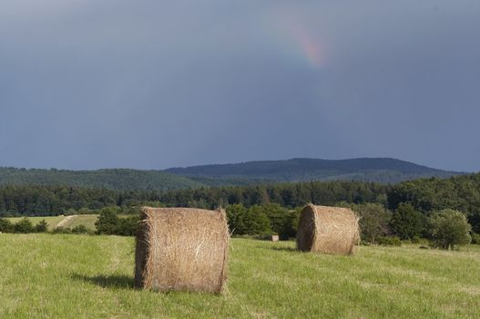 Shot of the dark sky with rainbow