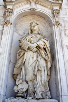 Close view of a statue of a women located on the entrance of the National Palace of Ajuda in Lisbon, Portugal.