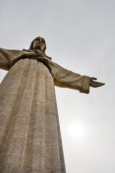 View of the tall stone statue of King Christ on Almada, Portugal.