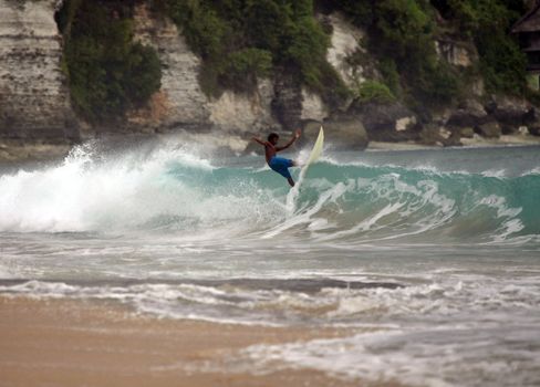 Young men - the surfer in ocean. Bali. Indonesia