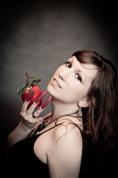 Pretty young lady with red apple and long nails