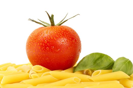 some raw penne rigate with wet tomato and basil on white background