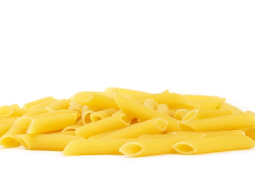 some raw penne rigate on white background