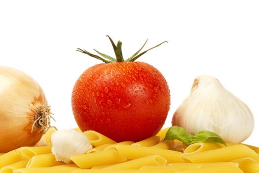 some raw penne rigate with wet tomato, onion, garlic, garlic clove and basil on white background