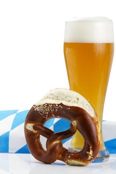 wheat beer with bavarian towel and pretzel on white background