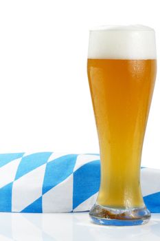 wheat beer with bavarian towel on white background