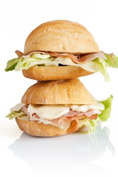 two sandwiches with ham, lettuce and mozzarella isolated on white background with clipping path