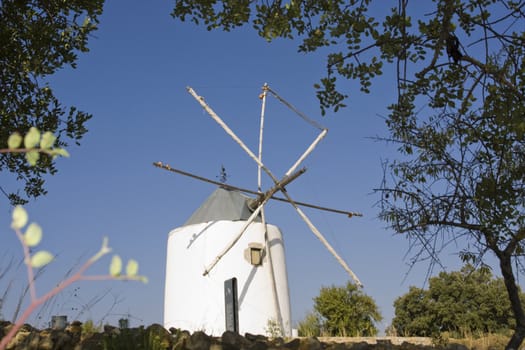 View of a typical portuguese windmill on top of the hill.