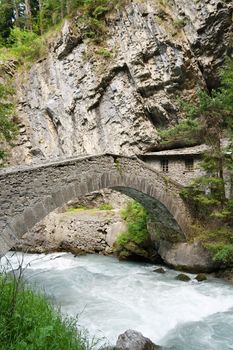 old stone bridge and home over Verney Dora in Pre Saint Didier, Aosta Valley, Italy