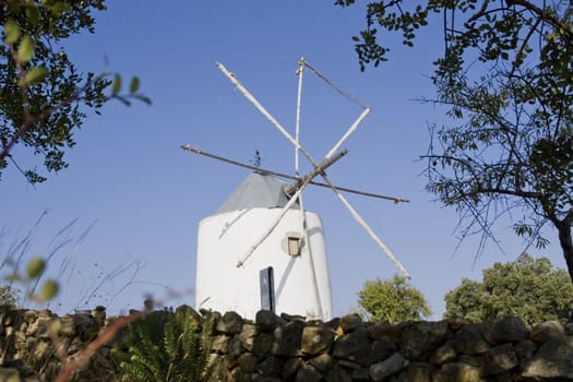 View of a typical portuguese windmill on top of the hill.