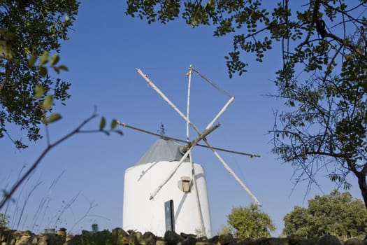 View of a typical portuguese windmill on top of the hill.
