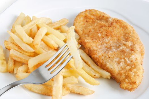 detail of fried potatoes and chicken with fork isolated on white background