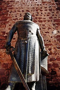 Low perspective angle view of the statue of portuguese king D.Sancho I located at the entrance of the castle of Silves, Portugal.