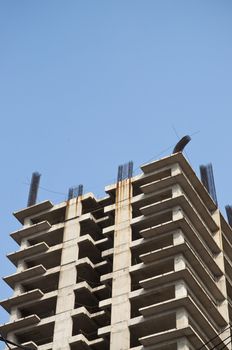 Skyscraper under construction in Jakarta city on blue sky