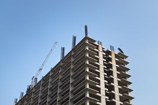 Skyscraper under construction in Jakarta city on blue sky