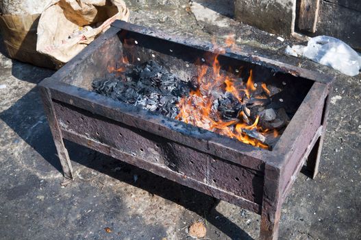 Brazier on a street in a poor suburb Jakarta 