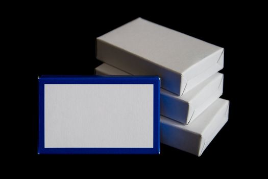 Blue and white carton boxes isolated on black background