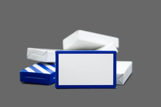 Blue striped and white carton boxes, piled heap.